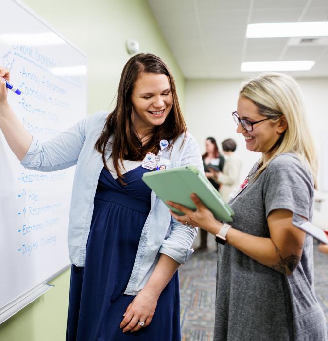 Instructor showing a student information in academic setting Centra College